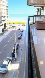 a balcony with cars parked in a parking lot at Quarto e Banheiro privativo Praia da Costa Pé Na Areia in Vila Velha