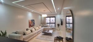 a living room with a couch and a table at Central Marrakech Sunny Stay Poolside Apartment in Gueliz in Marrakech
