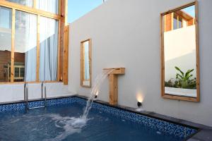 a swimming pool with a waterfall in a house at أكواخ السحاب in Jeddah +8 photos