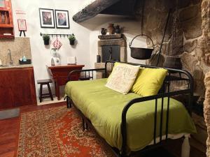 a bedroom with a bed and a kitchen with a table at Sidrós Houses in Vila Nova