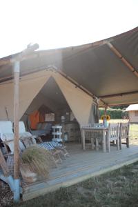 a tent with chairs and a table in a field at Meadow View Country Park in Horton