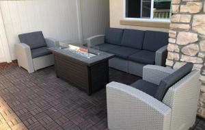 a living room with a couch and two chairs at The Lark House in Chula Vista