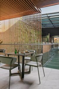 a table and chairs sitting on a patio at Casa Prim Hotel Boutique in Mexico City