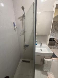 a bathroom with a shower and a sink at Entire Apartment with Garden in Sheikh Zayed +20 photos