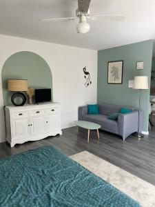 a living room with a couch and a table at L'Ecrin Angevin in Le Plessis-Grammoire