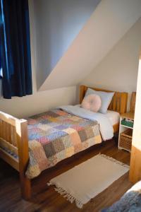 a bedroom with a bed with a quilt on it at Park Wilkasy in Gołdap +133 photos