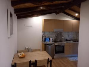 a small kitchen with a wooden table and a table and a wooden tableablish at House Guilho in Reriz