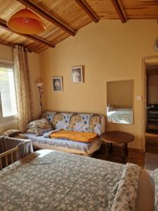 a living room with a couch and a table at Сocon bien douillet in Saint-Denis-dʼOléron
