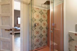 a shower with a glass door in a bathroom at Villa Corallo Cala Bianca in Castellammare del Golfo +25 photos
