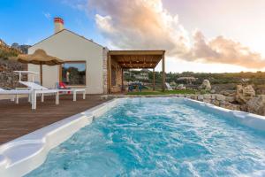 a swimming pool in the backyard of a house at Villa Corallo Cala Bianca in Castellammare del Golfo