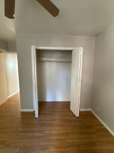 an empty room with a door and a wooden floor at Cabin in Tybee Island in Tybee Island