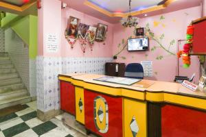 a restaurant with a colorful counter in a room at Hotel O Bideshini Hotel in Tarapith +45 photos