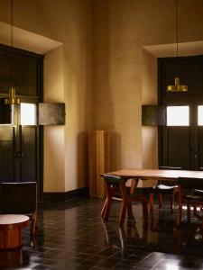 a dining room with a wooden table and chairs at Hotel Sevilla in Mérida