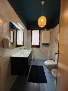 a bathroom with a sink and a toilet at B&B Pokerdassi in Leonforte +12 photos