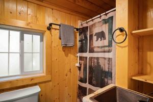 a bathroom with a toilet and a sink and a window at Harmels on the Taylor in Almont +77 photos