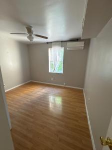 une chambre vide avec un ventilateur de plafond et une fenêtre dans l'établissement Full House in Tybee Island, Georgia, à Tybee Island