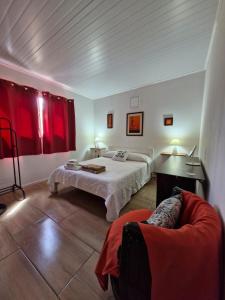 a bedroom with a bed and a couch in it at Hermosa casa a estrenar en Playa Grande ELIXIR in San Gregorio de Polanco +30 photos