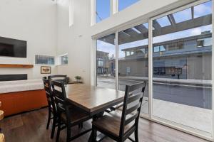 a dining room with a table and chairs and a large window at Quarry B5 in Whitefish
