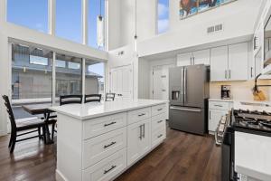 a kitchen with white cabinets and a table and a refrigerator at Quarry B5 in Whitefish