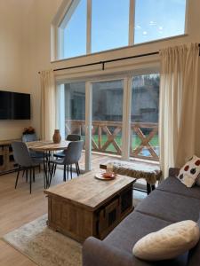 a living room with a couch and a table at Polana House in Niedźwiada
