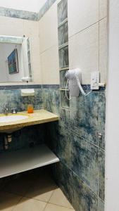 a bathroom with a sink and a mirror at Clorinda Departamentos in Clorinda