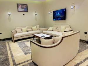 a living room with two couches and a table at desert rose hotel-فندق ديزرت روز in Siwa