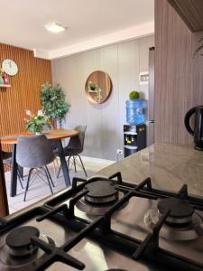 a stove top in a kitchen with a table at Dep 3 habitaciones 1,5 baños céntrico parking wif TV en habitaciones in Rancagua +14 photos