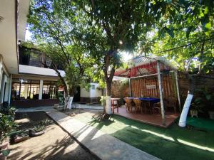 a house with a gazebo with a table in the yard at Hotel D' Palacio Real in San Miguel