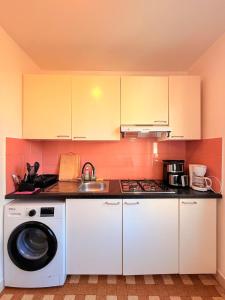 a kitchen with a washing machine and a sink at Maison Bon Séjour in Livry-Gargan +21 photos