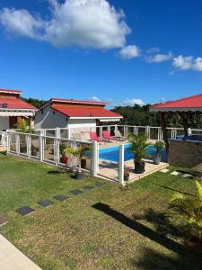 a view of a house with a swimming pool at Le Doux Paradise- GOYA in Sainte-Rose +3 photos