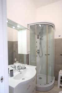 a white bathroom with a sink and a shower at L'angolo del viaggiatore in Nicosia +13 photos