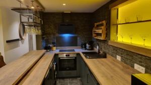 a kitchen with a wooden counter top and a sink at Ferienhaus Strandschnecke in Dornumersiel