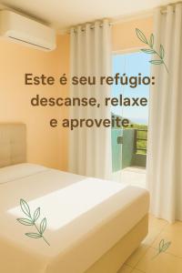 Ένα ή περισσότερα κρεβάτια σε δωμάτιο στο Vista deslumbrante do Santinho! +8 φωτογραφίες