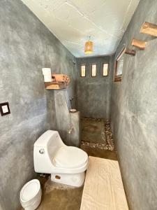 ein Badezimmer mit einer weißen Toilette in einem Zimmer in der Unterkunft Casa Siddhartha in Mazunte