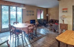 a living room with a table and chairs and a couch at Stunning Home In Mombrier With Private Swimming Pool, Can Be Inside Or Outside in Mombrier
