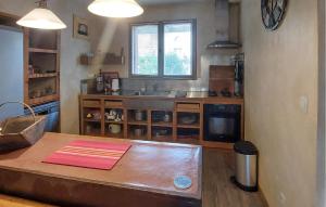 a kitchen with a wooden table and a sink at Stunning Home In Mombrier With Private Swimming Pool, Can Be Inside Or Outside in Mombrier