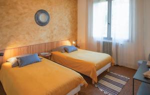 a hotel room with two beds and a window at Stunning Home In Mombrier With Private Swimming Pool, Can Be Inside Or Outside in Mombrier +14 photos