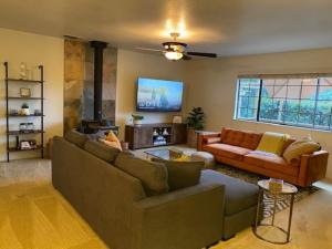 a living room with a couch and a fire place at Cozy Cabin Near Yosemite & Bass lake, Breathtaking Views & Private Hot Tub, BBQ, Nature Getaway in Oakhurst