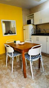 a dining room table with two chairs and a kitchen at Departamento Baba in Clorinda