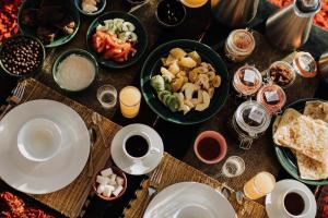 a table with plates of food and cups of coffee at Dar Nomad Tagounite in Zagora