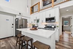 a kitchen with a large white counter and stools at Quarry B10 in Whitefish
