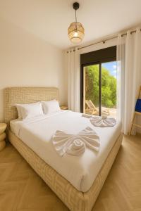 Una cama o camas en una habitación de Atlas Golf Resort Marrakech