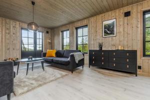a living room with a couch and a table at Fjellperlen, Hardangervidda in Eidfjord