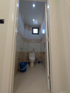 a small bathroom with a toilet and a window at F3 Neuve in Oran +11 photos