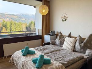 a bedroom with a bed and a large window at Appartement Oriold in Bad Goisern