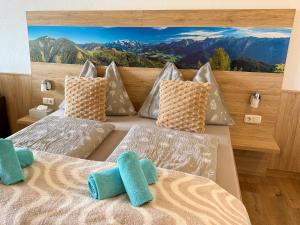 a bedroom with two beds with a view of mountains at Appartement Oriold in Bad Goisern