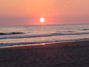 a sunset on the beach with the ocean at Chak in Tonalá +5 photos