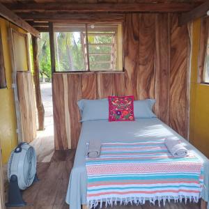 a bedroom with a bed in a wooden room at Chak in Tonalá