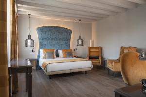 a hotel room with a bed and a chair at Hotel Campo Marzio in Vicenza +68 photos