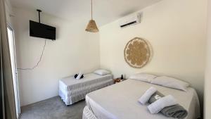 Postel nebo postele na pokoji v ubytování Chalé Begê